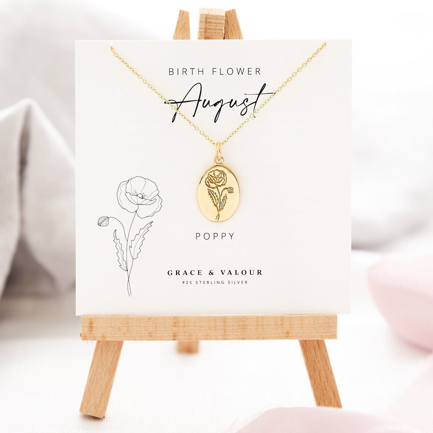 August Birth Month Gold Plated Flower Necklace, designed by Grace and Valour, sweet little oval flower necklace on the gift card that goes with the birth month, in this case its a Poppy flower gift card. The necklace can be engraved on the back with your personal message.