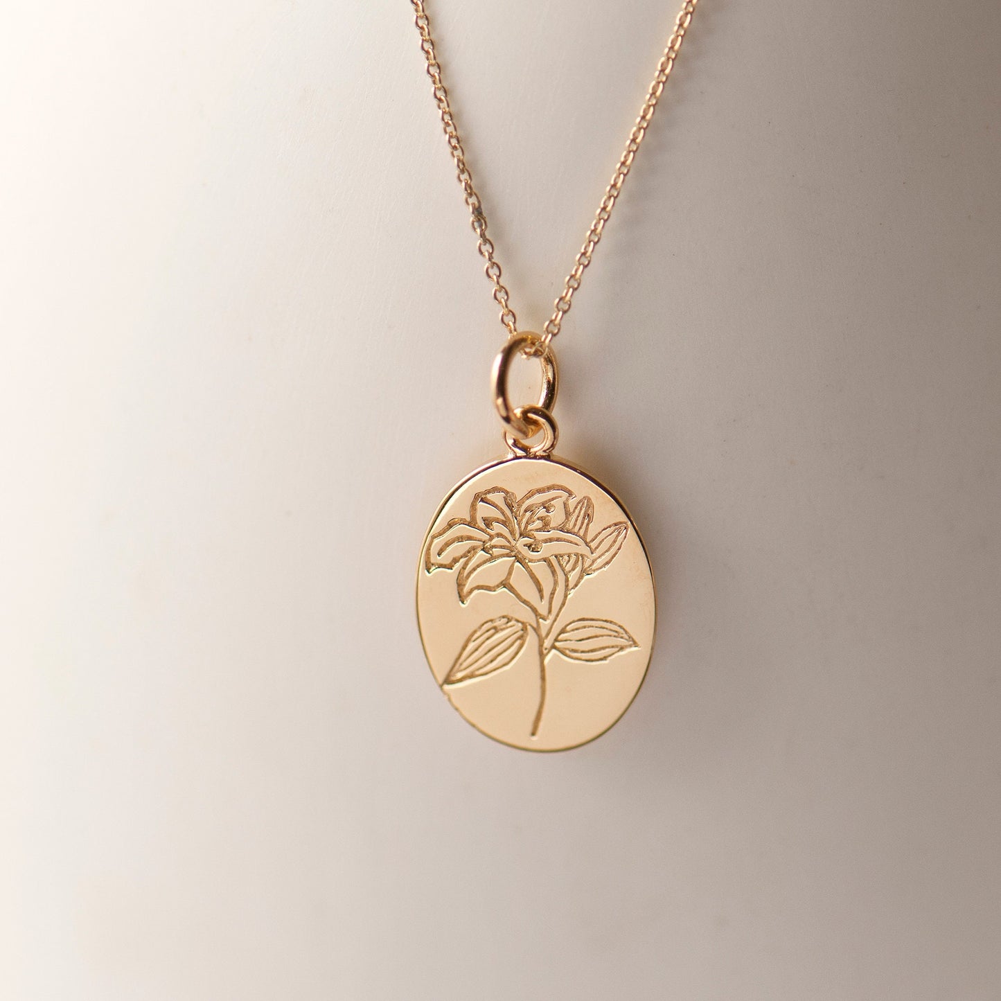 Gold plated engraved lily flower necklace, made from sterling silver and arrives on our bespoke Lily flower giftcard with information on the meanings of the lily flower - floriography. Designed by Rachel - Grace & Valour