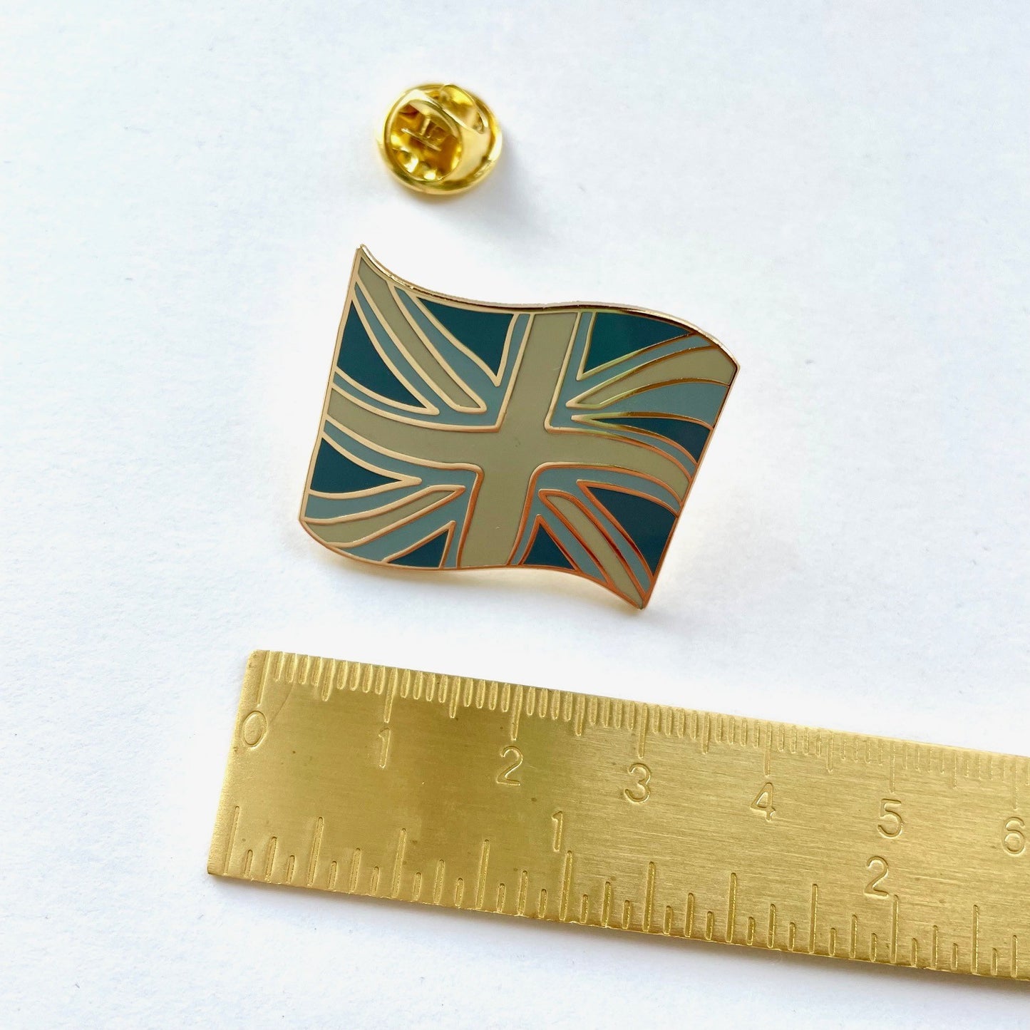 Close up of the coastal colours union flat, british flag pin designed by Rachel, Grace & Valour