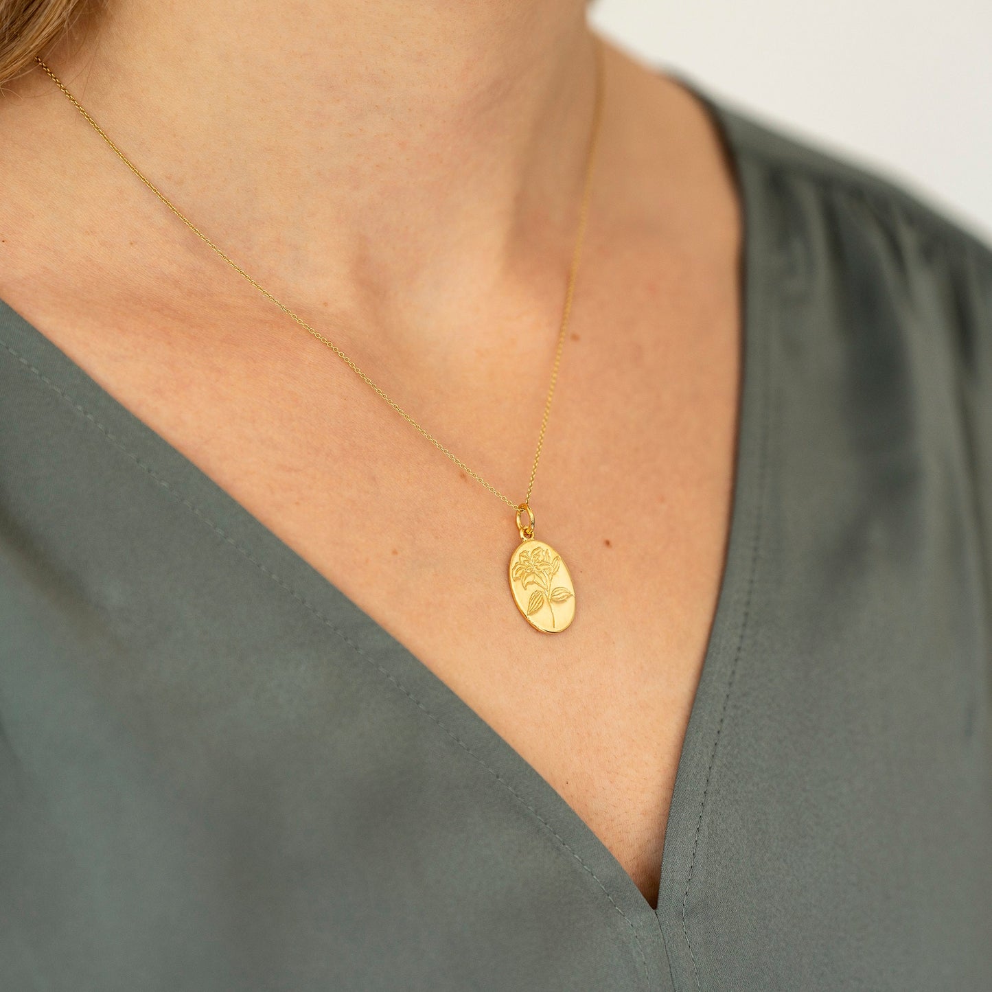 Gold plated engraved lily flower necklace, made from sterling silver and arrives on our bespoke Lily flower giftcard with information on the meanings of the lily flower - floriography. Designed by Rachel - Grace & Valour