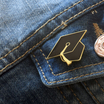 Mortar board enamel pin on a denim jacket pocket, the perfect gift for graduation