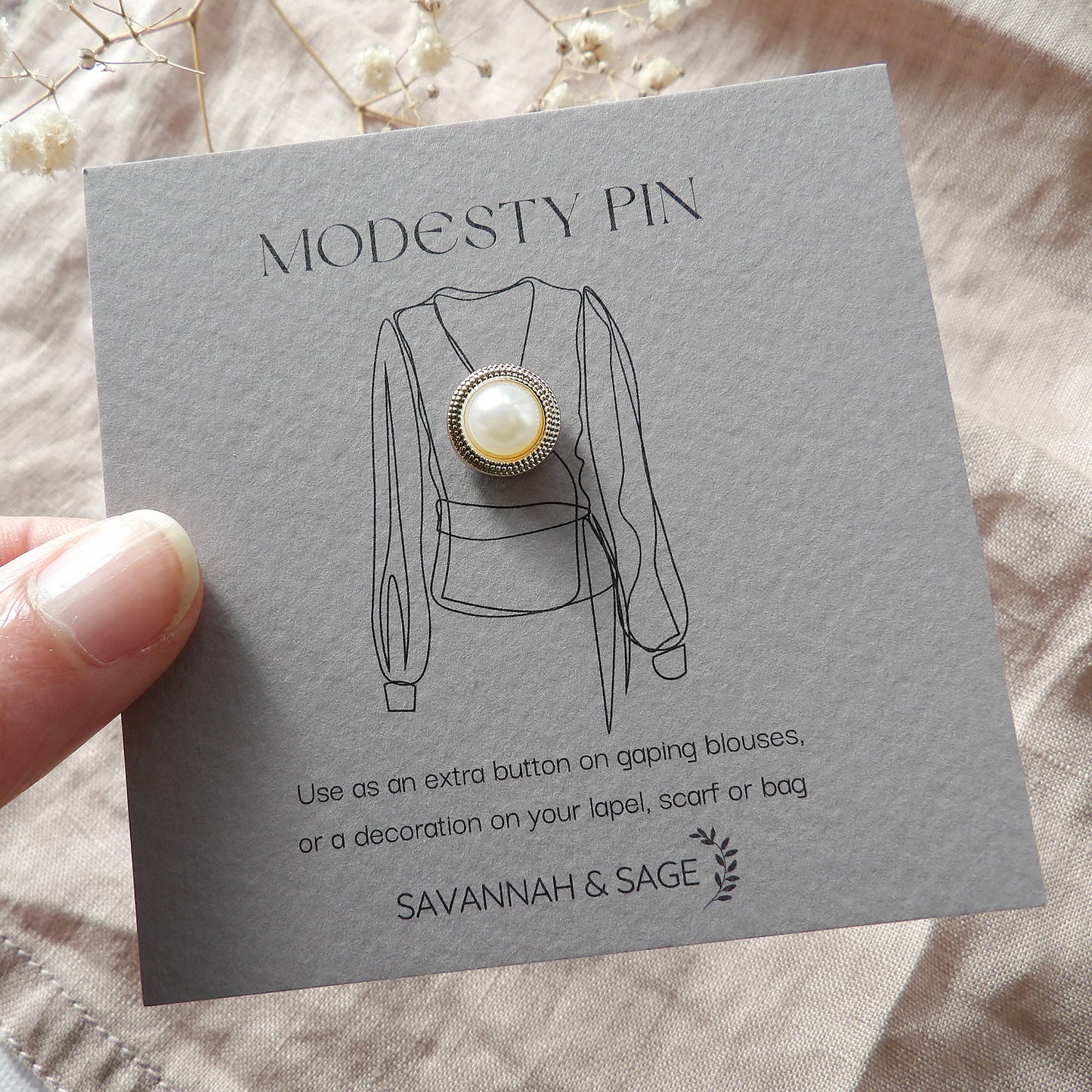 Pearl and gold modesty pin with border edge design