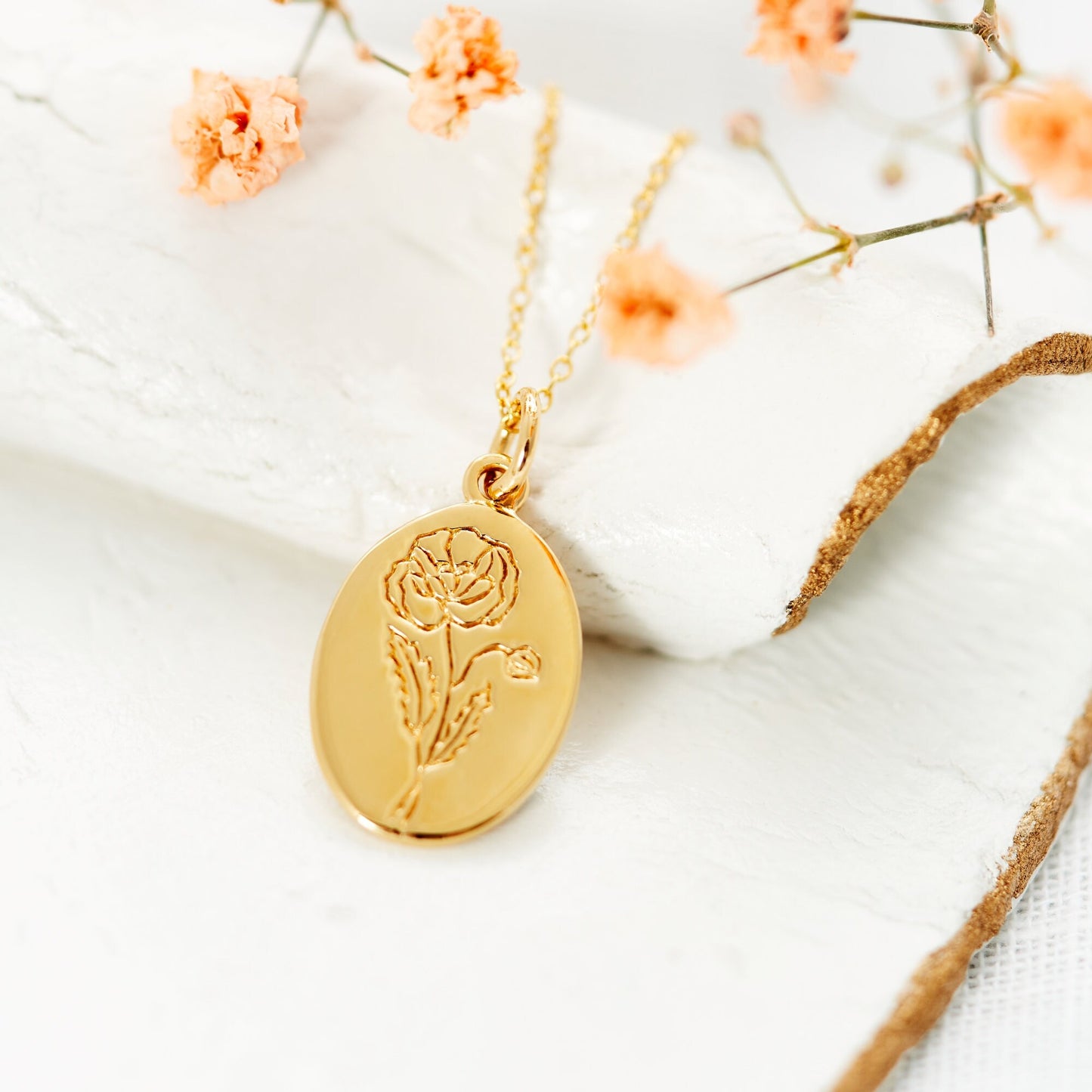 Poppy Birthflower Necklace, gold plated, close up image showing detail. Oval flower necklace for those born in August under the flower sign of the poppy. Made from Sterling silver 925 and gold plated to one micron, the necklace sits on a 16-17.5 inch matching cable chain.