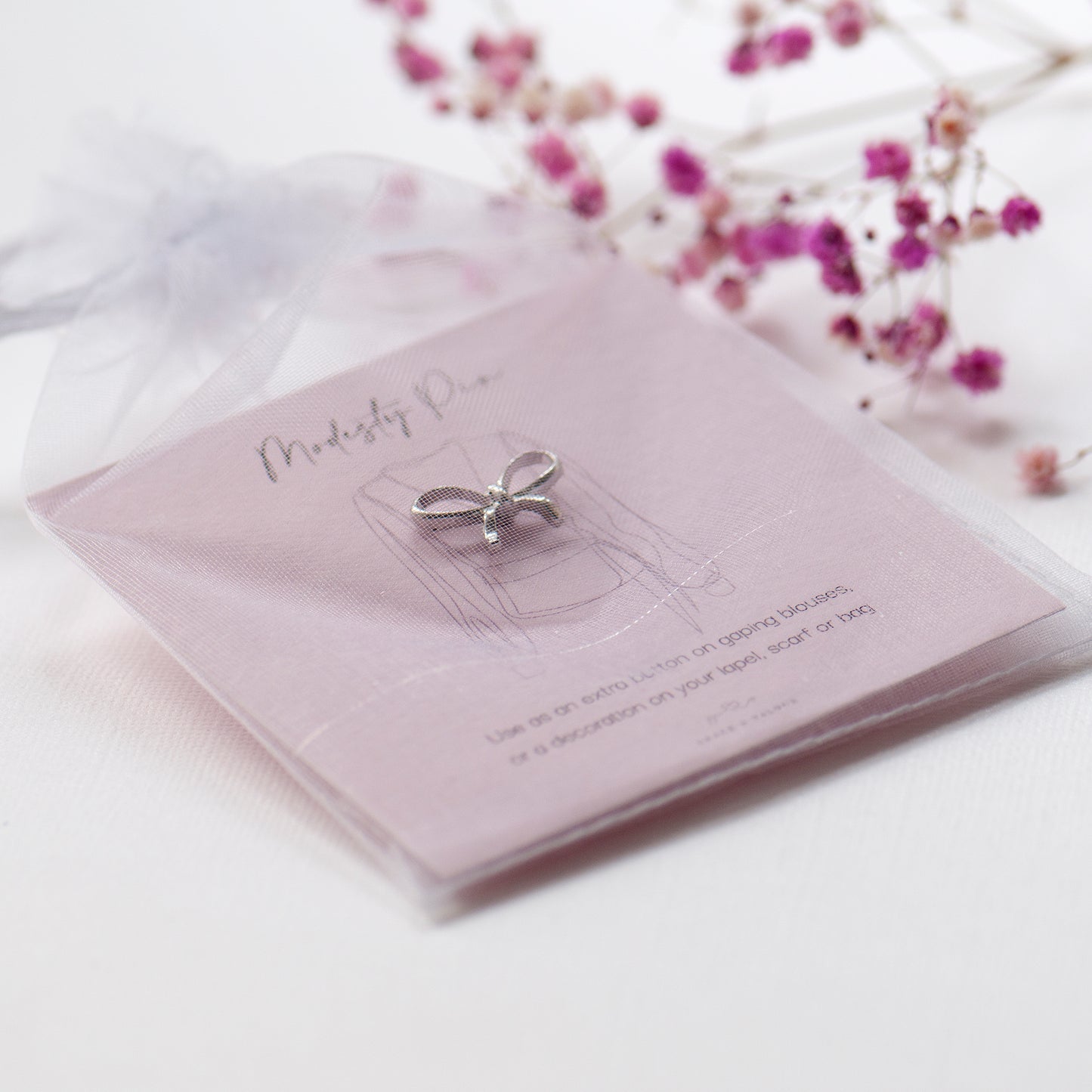 Silver bow modesty extra button pin on modesty gift card, in chiffon pouch ready for gifting. Gifts under £10
