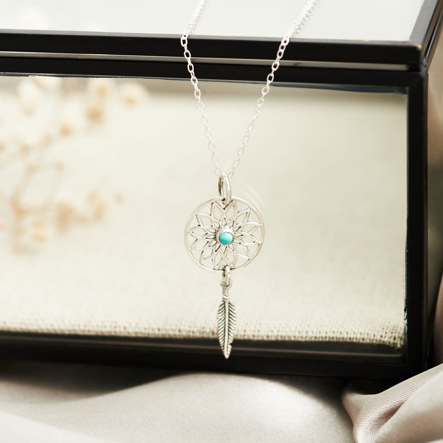 Dream catcher sterling silver necklace with turquoise stone at the centre and dangling silver feather motif, on bespoke gift card that says - May all your dreams come true
