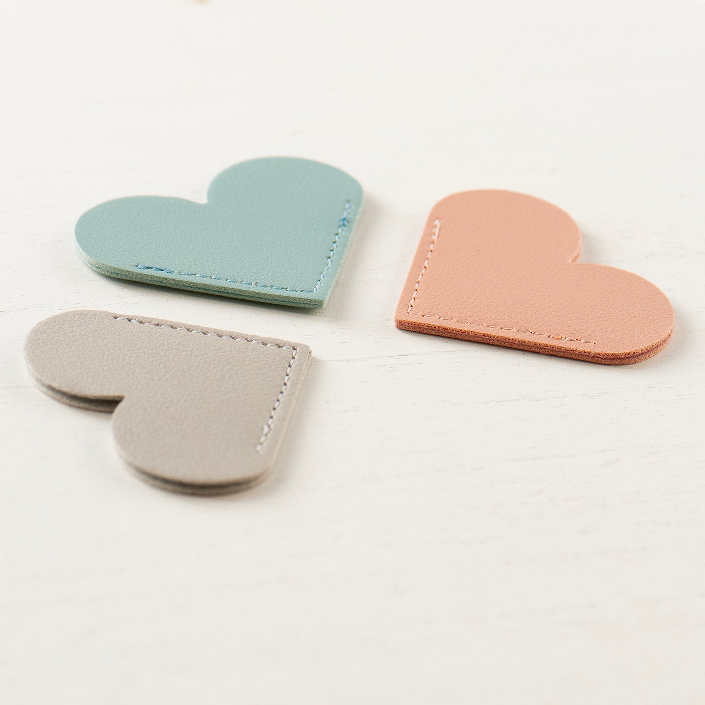 Three colours of faux leather heart bookmark, smoke rose, seasalt blue & dove grey