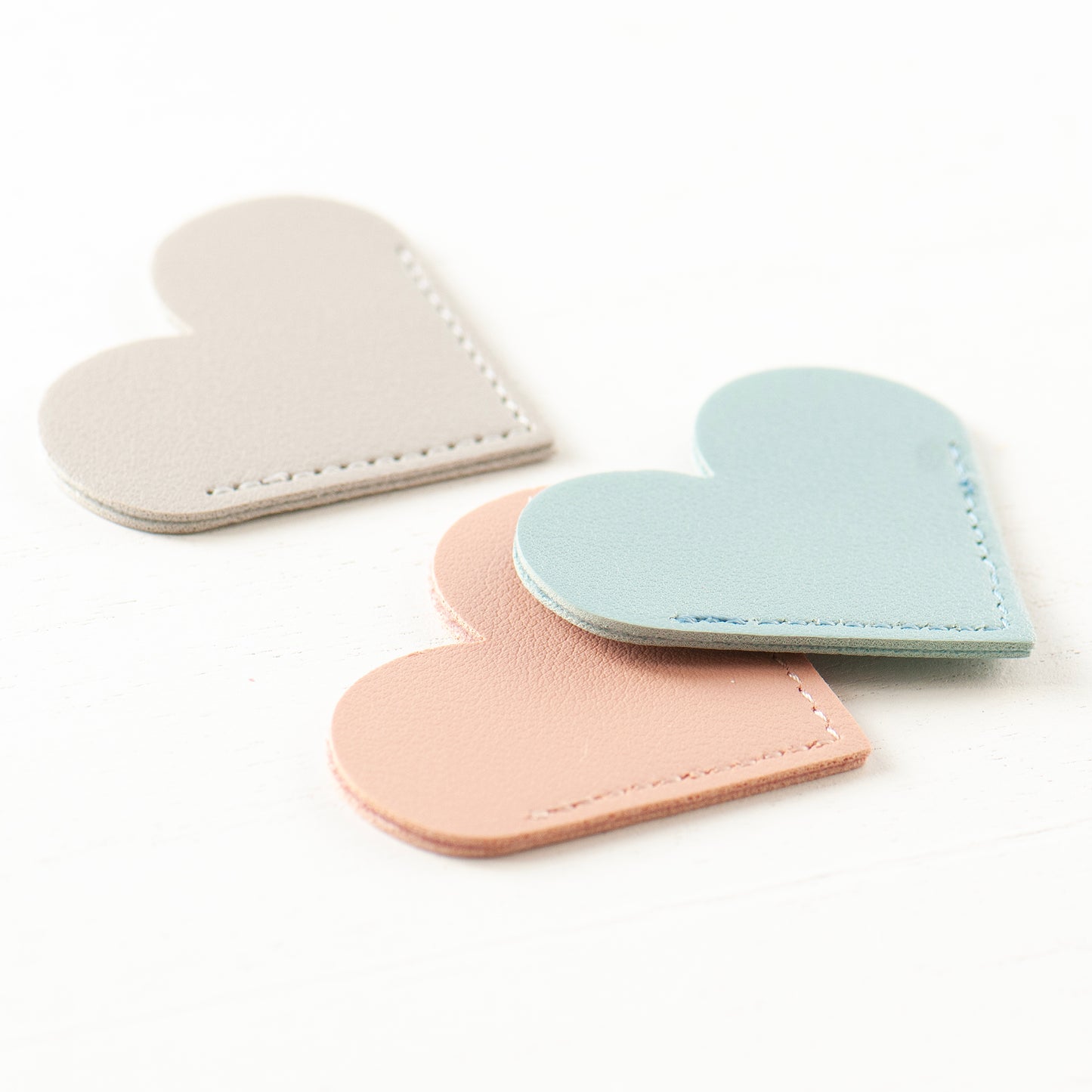 Three colours of faux leather heart bookmark, smoke rose, seasalt blue & dove grey