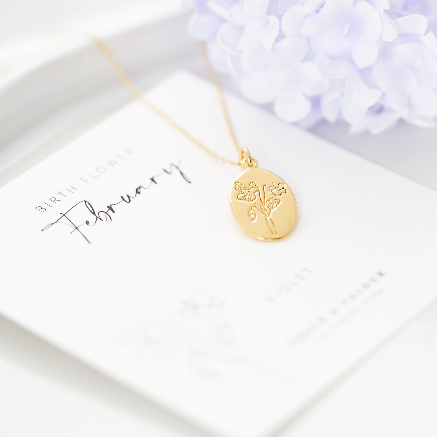 Violet flower engraved necklace, violet is the birth flower for february. Sterling silver oval pendant, gold plated and engraved beautifully - Designed by Rachel, Grace & Valour. Ideal gift for a february birthday, gift for her, bridesmaid gift, wedding gift, mothers' day gift, gift for her