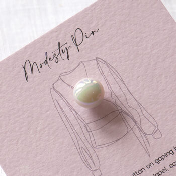 close up of ceramic modesty pin on gift card