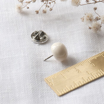 close up of ceramic modesty pin showing the pin and backing lock