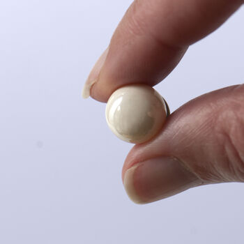 close up of ceramic modesty pin showing the pin size
