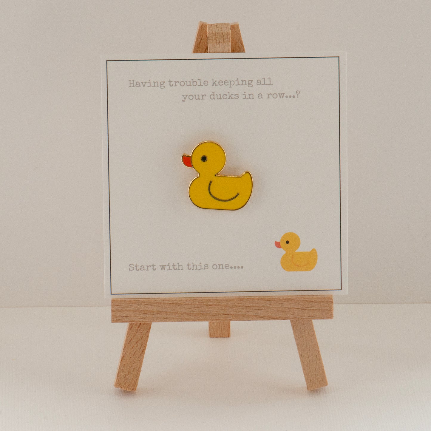 ducks in a row giftcard with a cute yellow enamel rubber duck pin