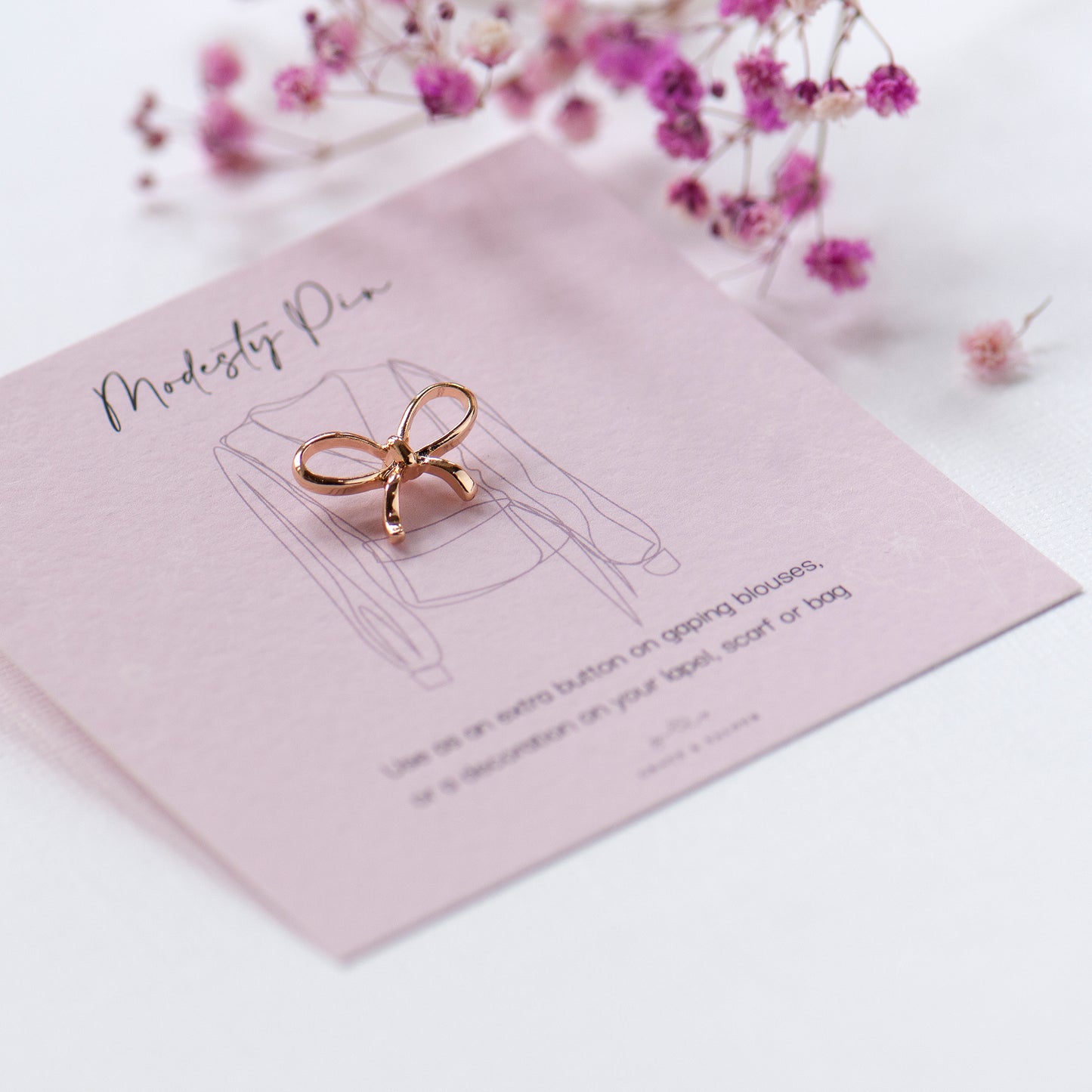 gold bow modesty pin on gift card ready for gifting, gifts under £10