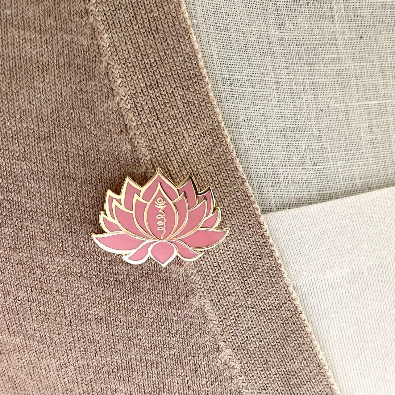 pink and gold lotus flower pin on lapel, showing the unalome symbol picked out in gold. Gifts under £10, Flower lover gift, gift for her
