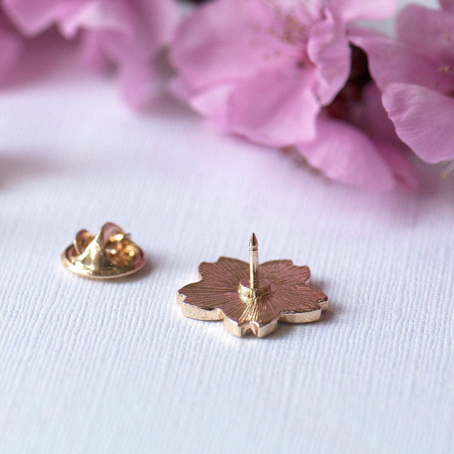 The back of the blossom enamel pin showing the fastener