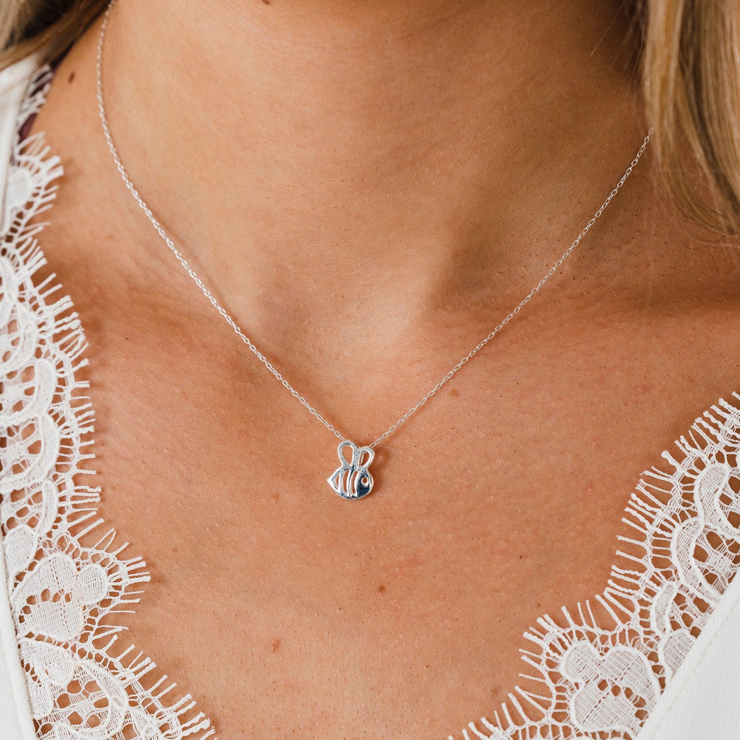 Bee sterling silver necklace on model - Grace & Valour