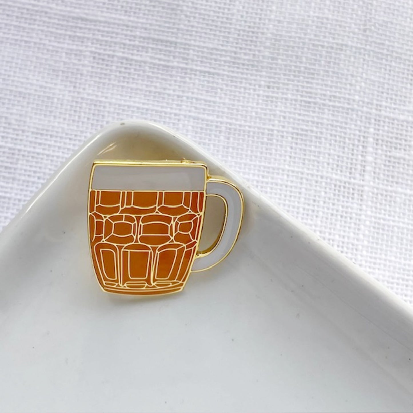 Enamel pin of an old fashioned pint of beer.