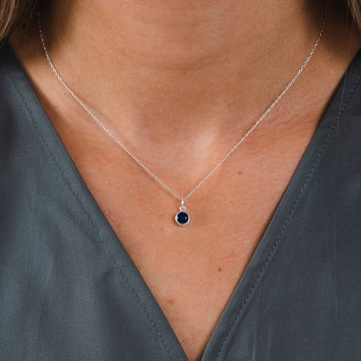 model is wearing the september birthstone necklace