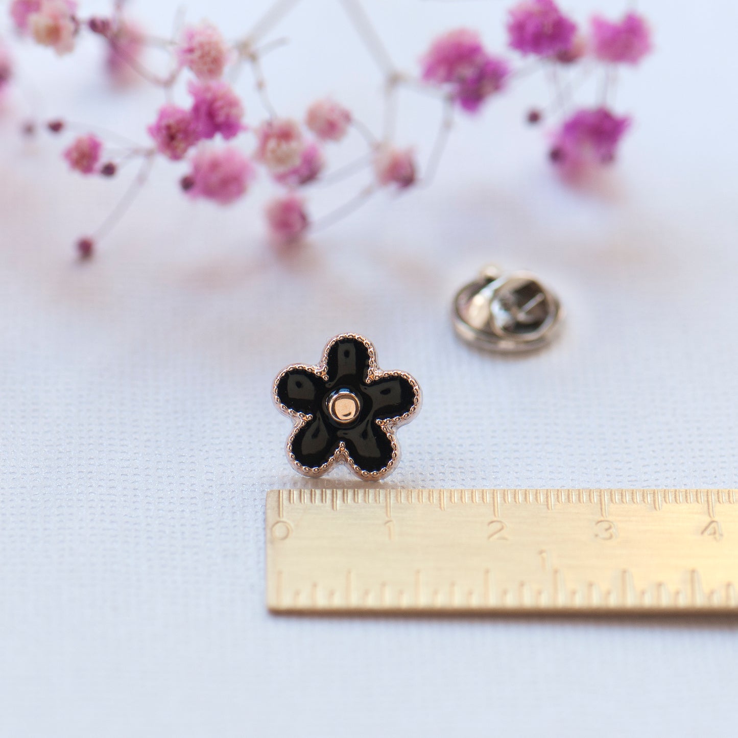 Black enamel flower and gold modesty pin