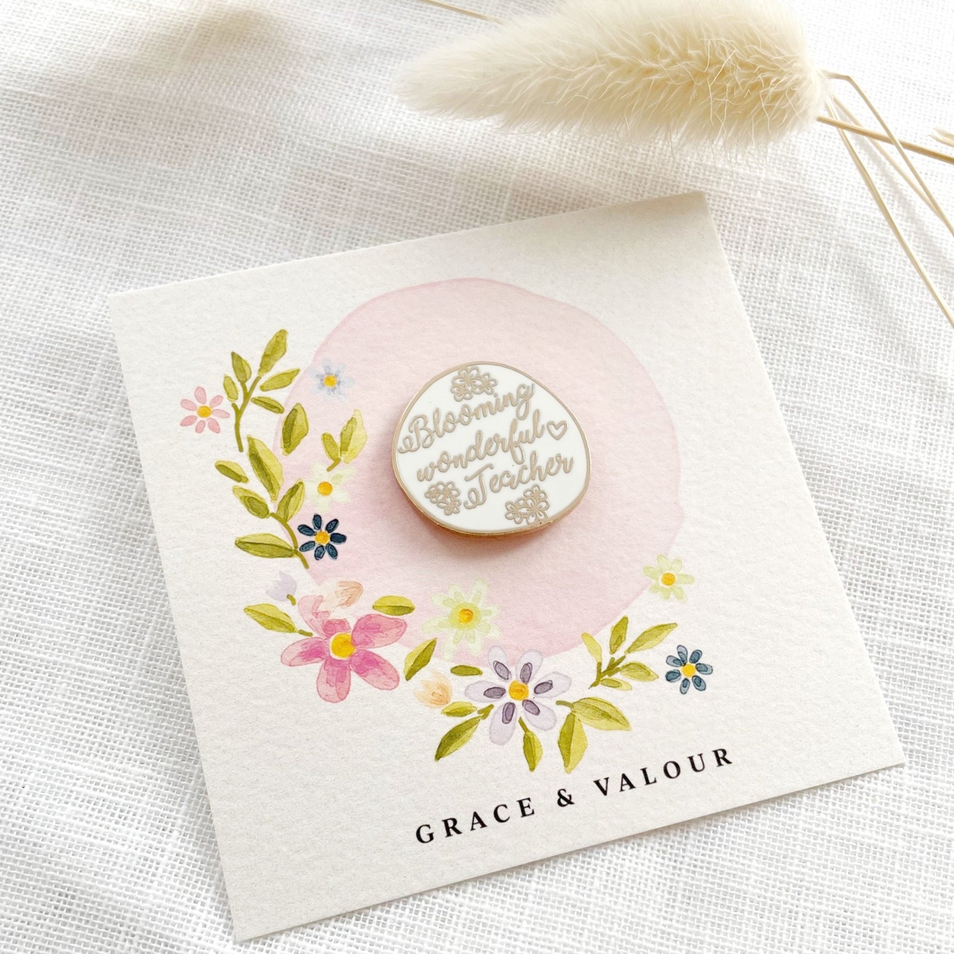 Card with a blooming wonderful teacher pin and floral design.