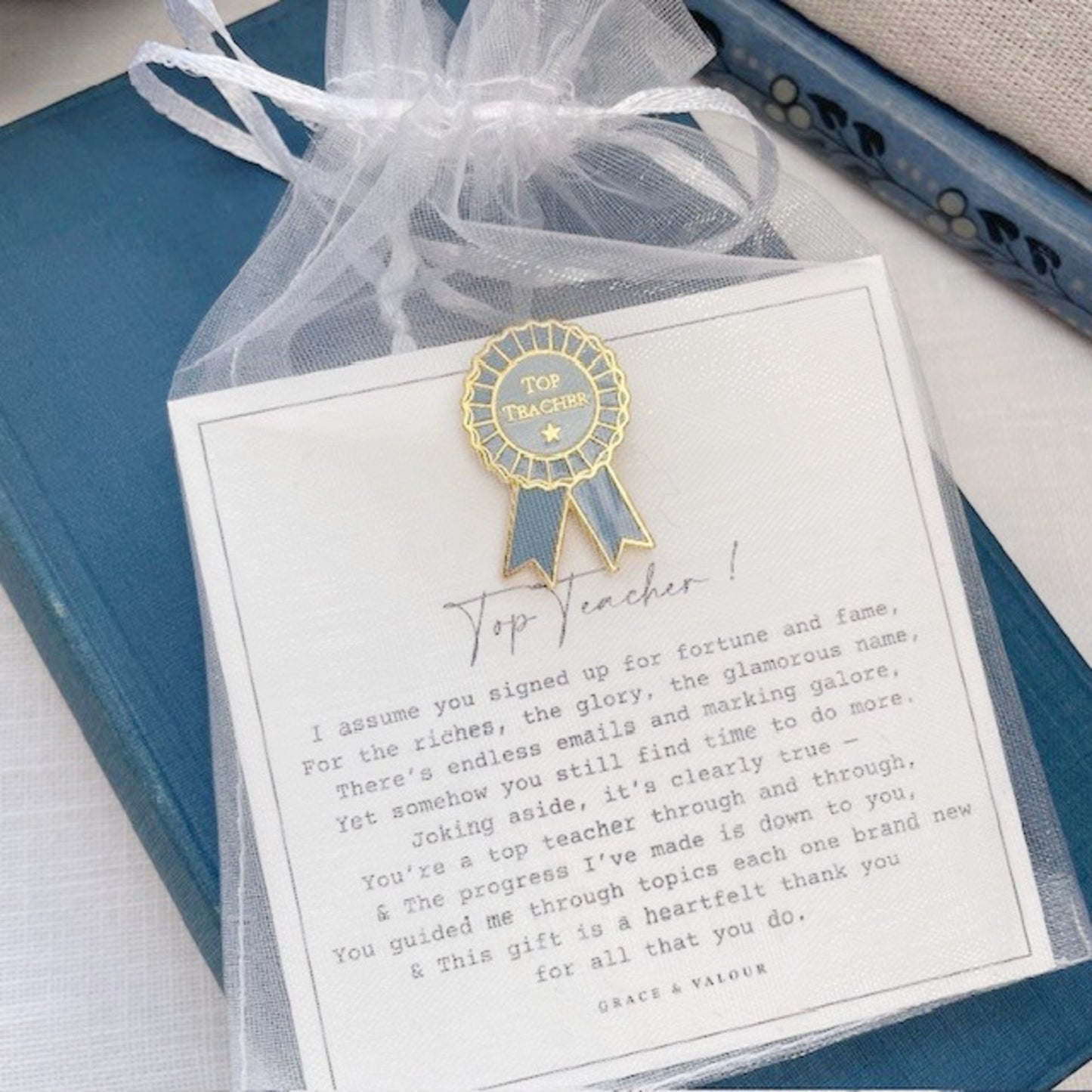 Card with a gold and blue ribbon badge and a message on a white background