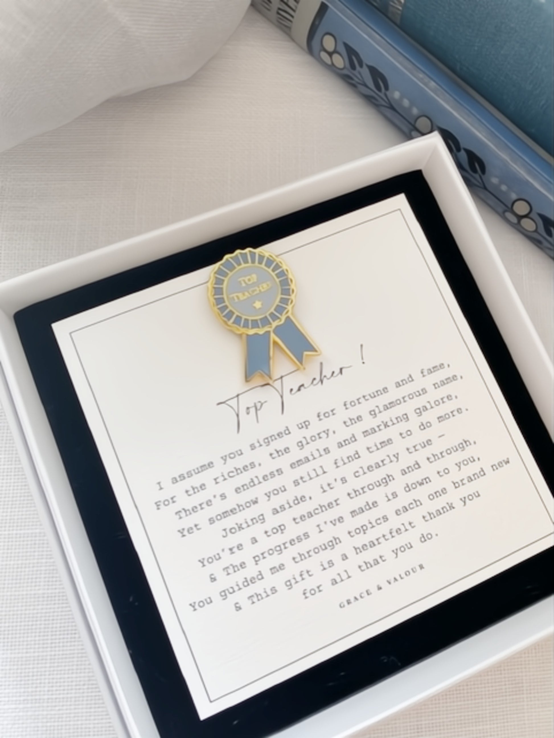 Gift card with a blue ribbon design and text in a box on a white surface