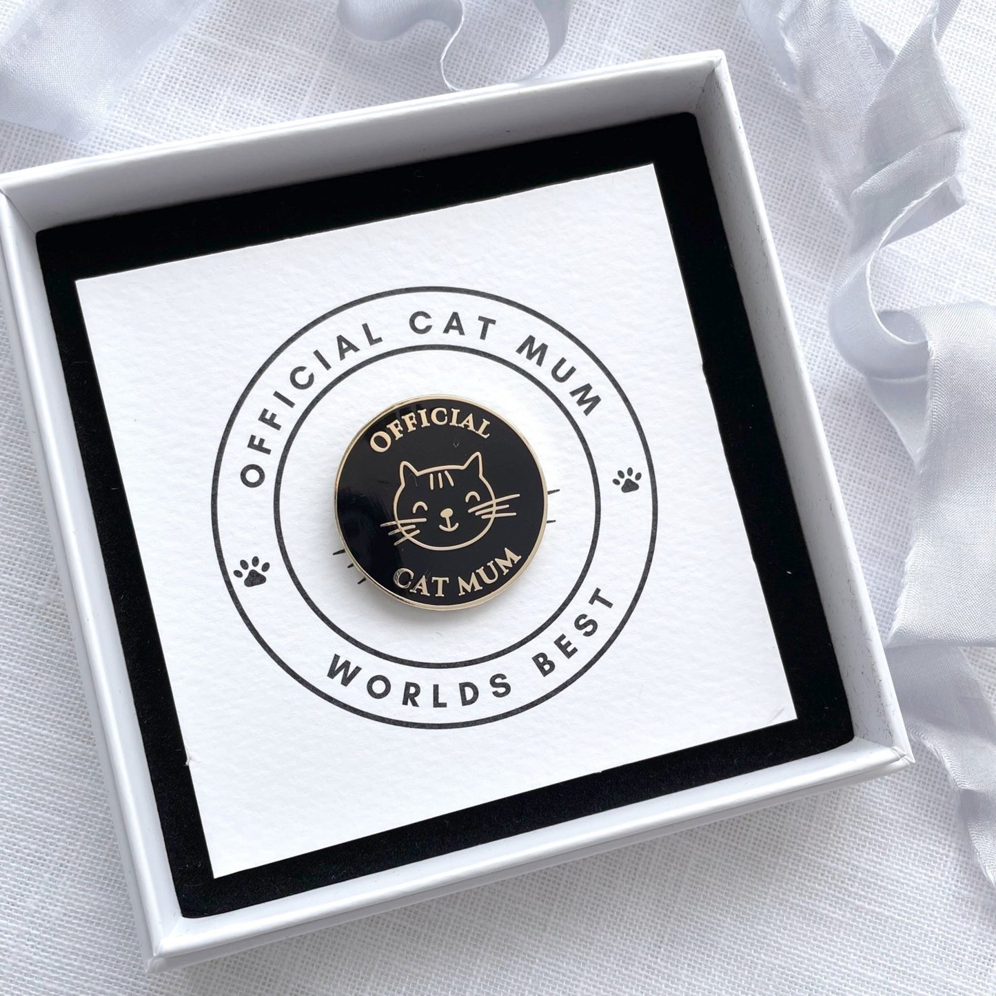 Cat-themed badge in a white box with a black and white background