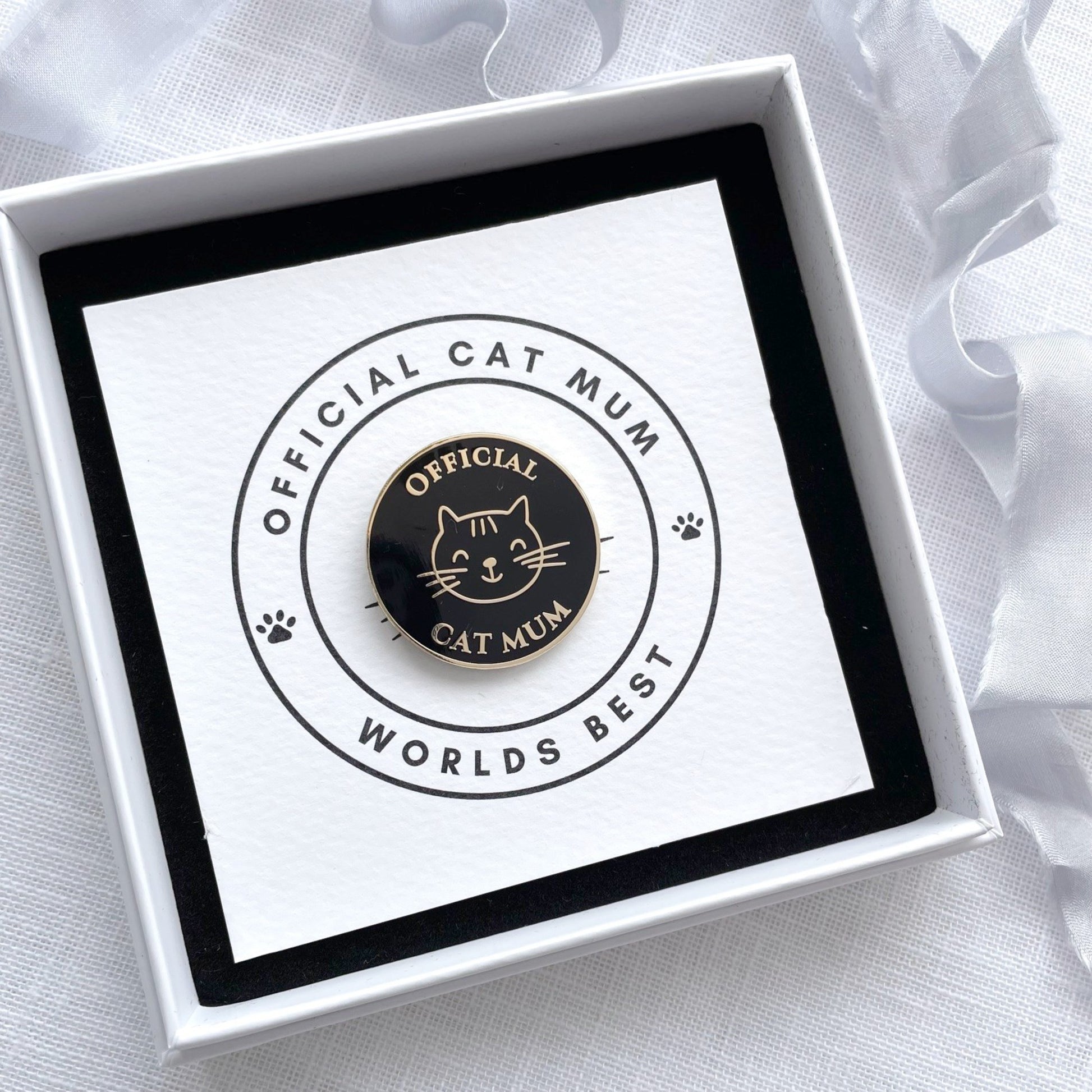 Cat-themed badge in a white box with a black and white background