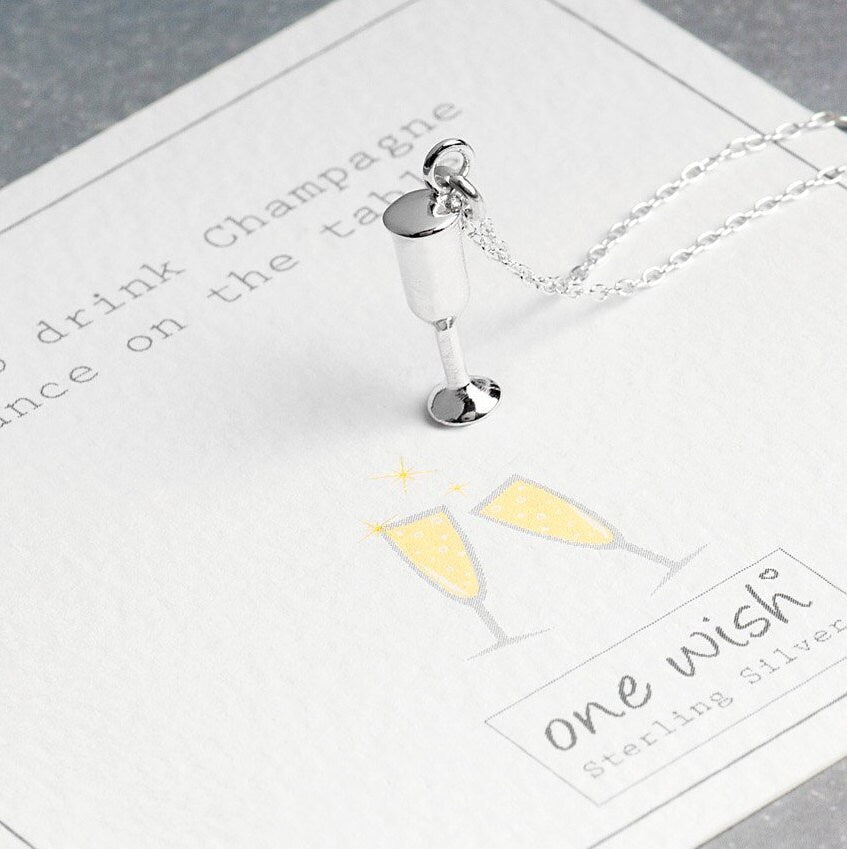 champagne pendant on chain on gift card with a quote about celebrating with champagne