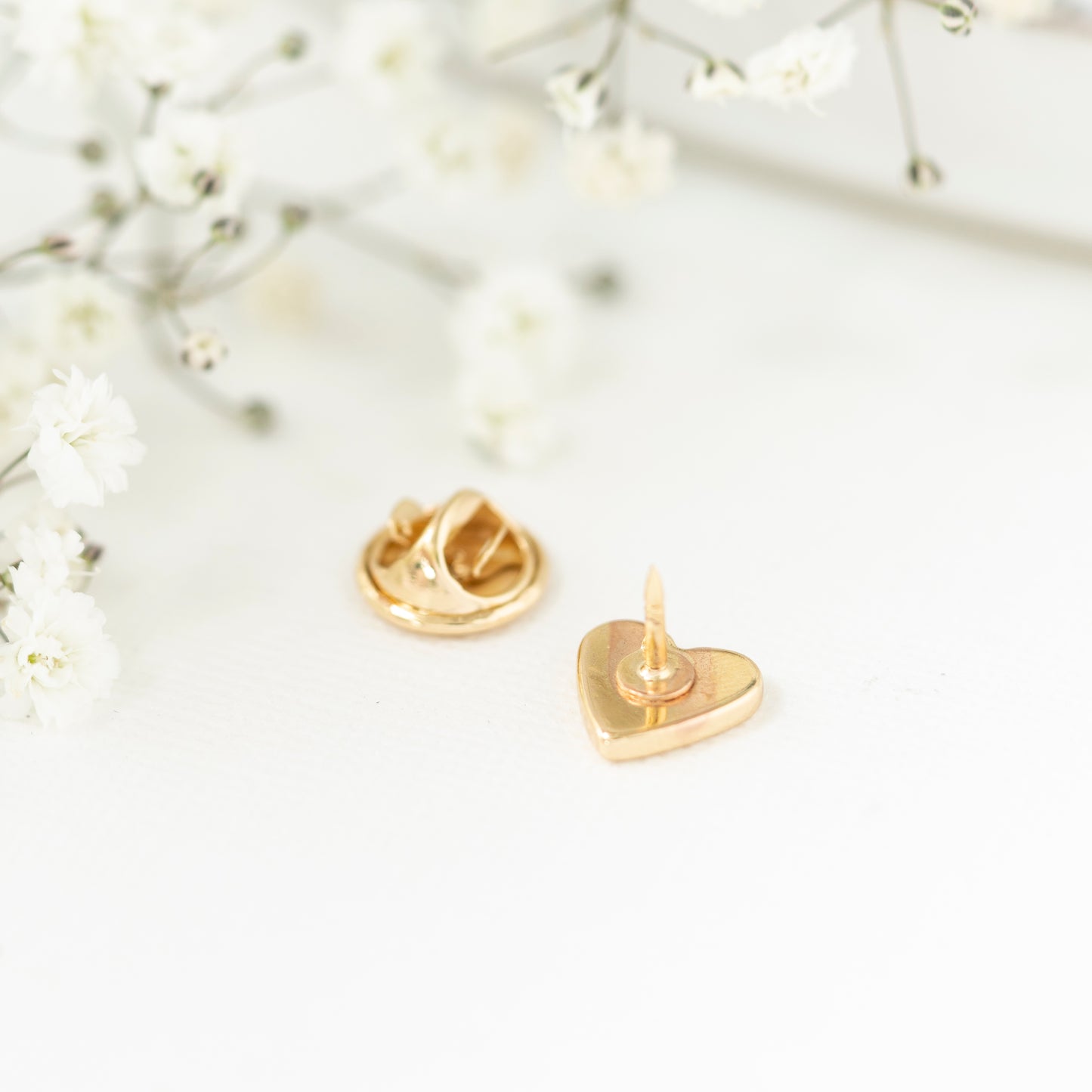 Close up gold plated heart pin teacher gift