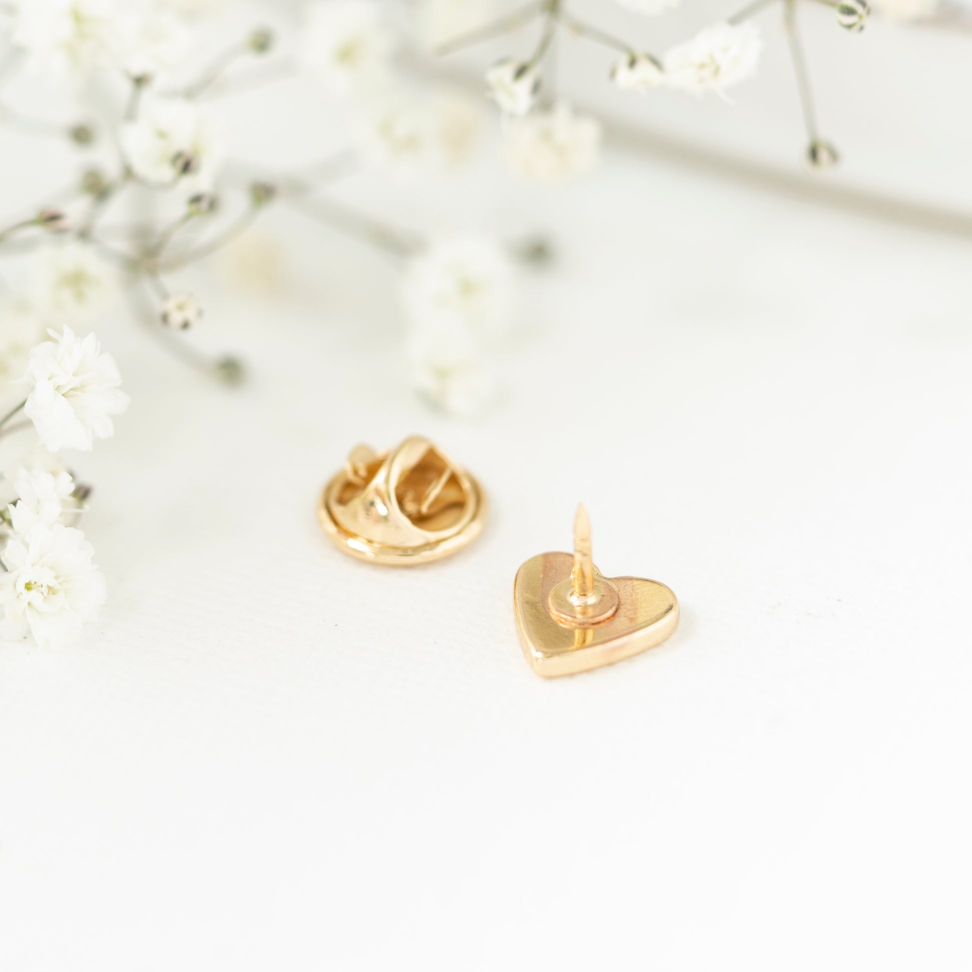 Close up gold plated heart pin teacher gift