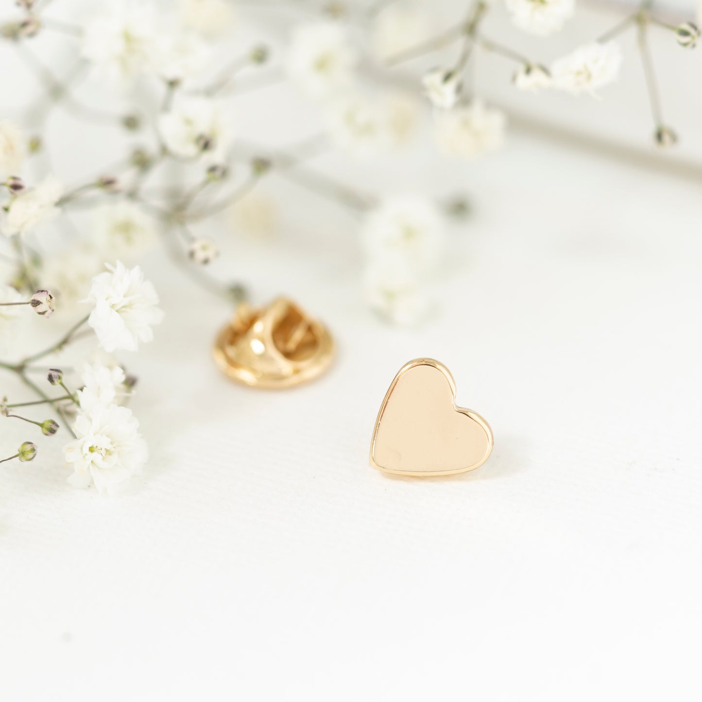 Close up gold plated heart pin teacher gift