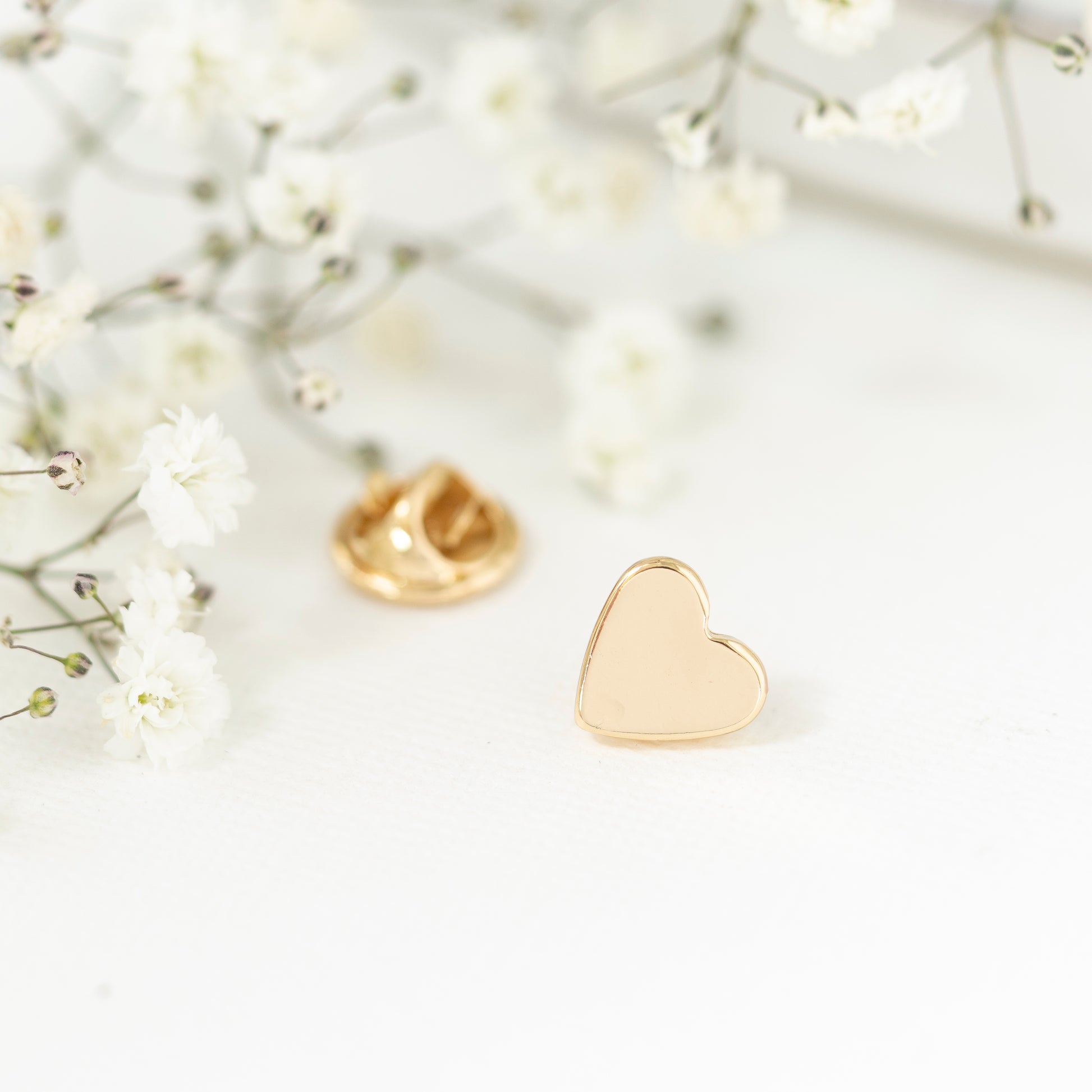 Close up gold plated heart pin teacher gift