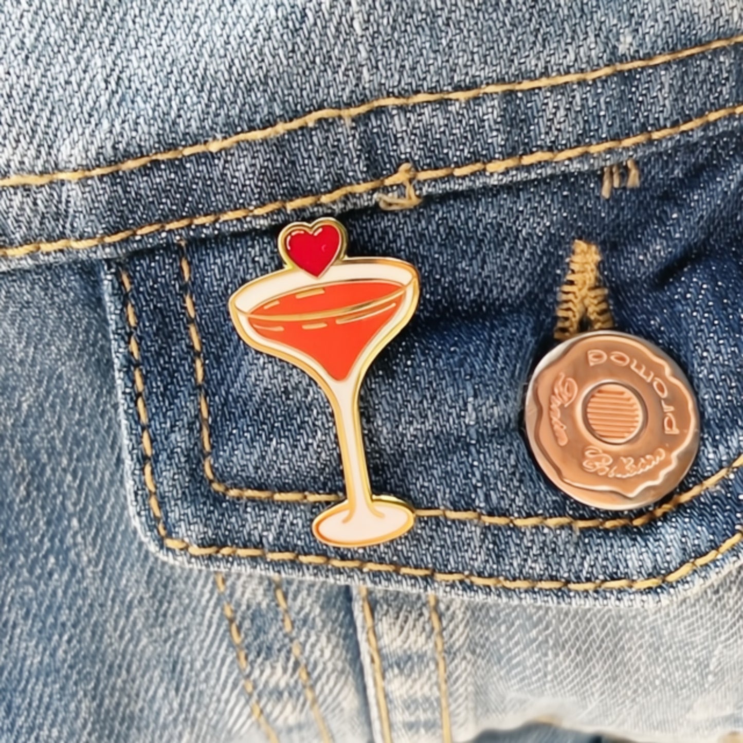 Pin with a cocktail design and heart on denim fabric