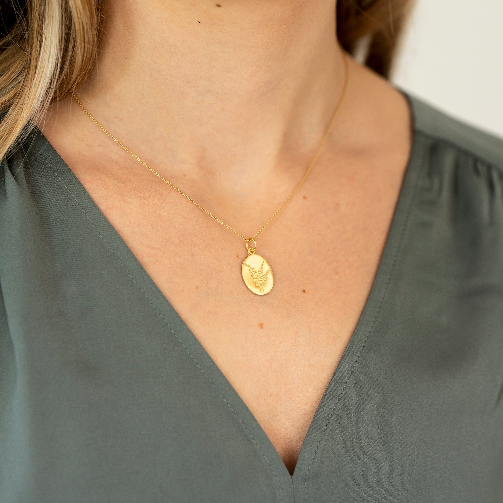 Model wearing lucky heather gold oval necklace