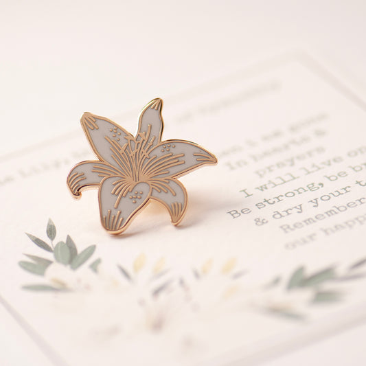 White and gold lily pin, on bespoke gift card which reads 'When i am gone, in hearts & prayers i will live on. Be strong, be brave & dry your tears. Remember all our happy years. Designed by Rachel - Grace & Valour