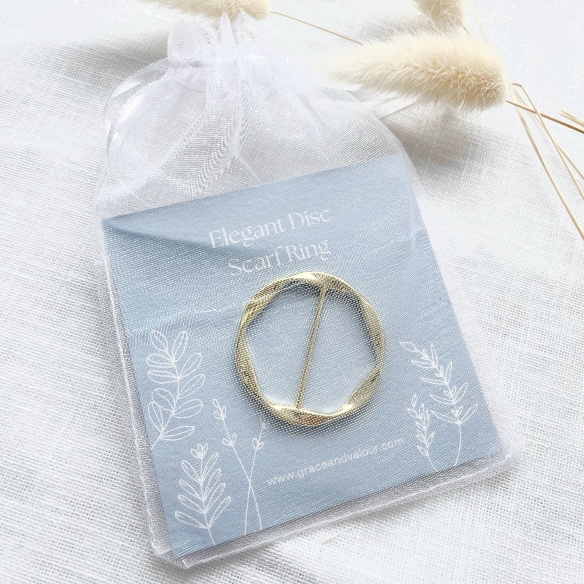 Gold scarf ring on a branded card in a chiffon pouch, ready for gifting