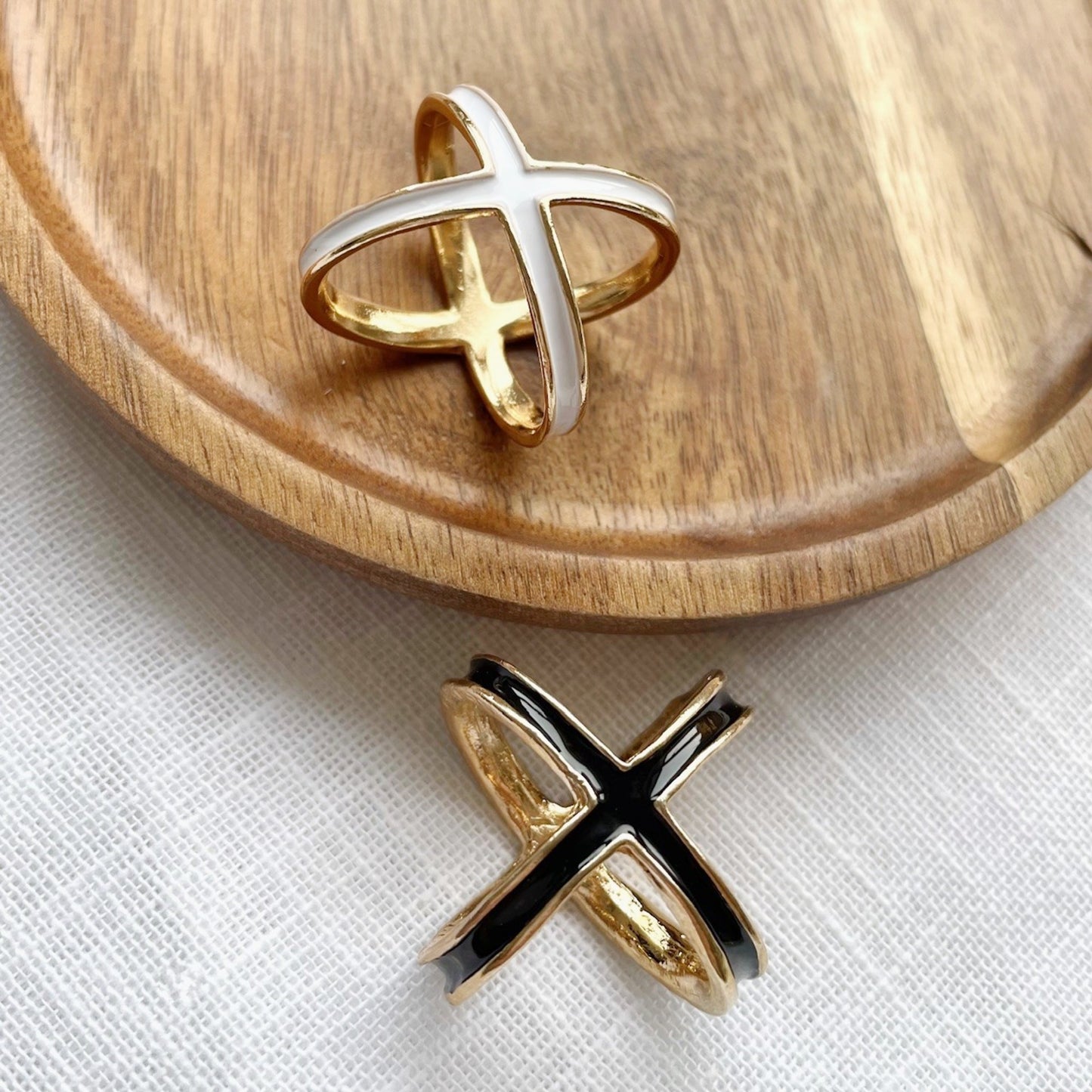 white or black and gold enamel four way scarf rings close up