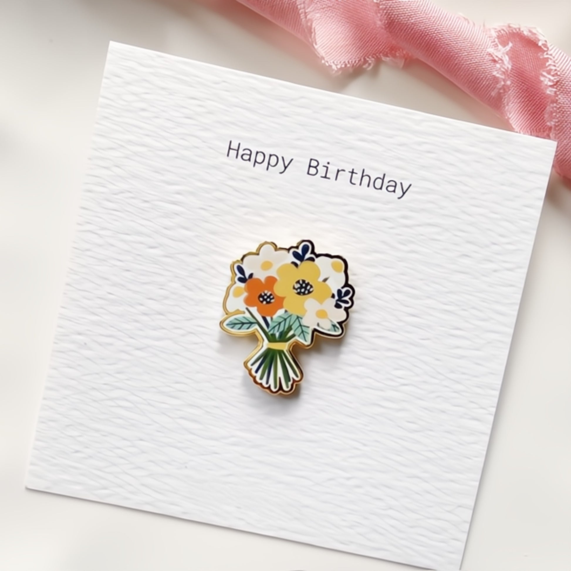 Bunch of cheerful orange and yellow flowers enamel pin on a 'Happy Birthday' card.