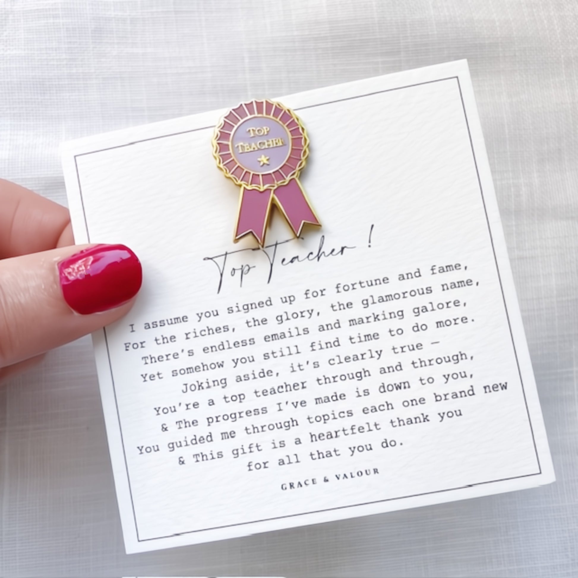 Top Teacher award pin on a card with a humorous message