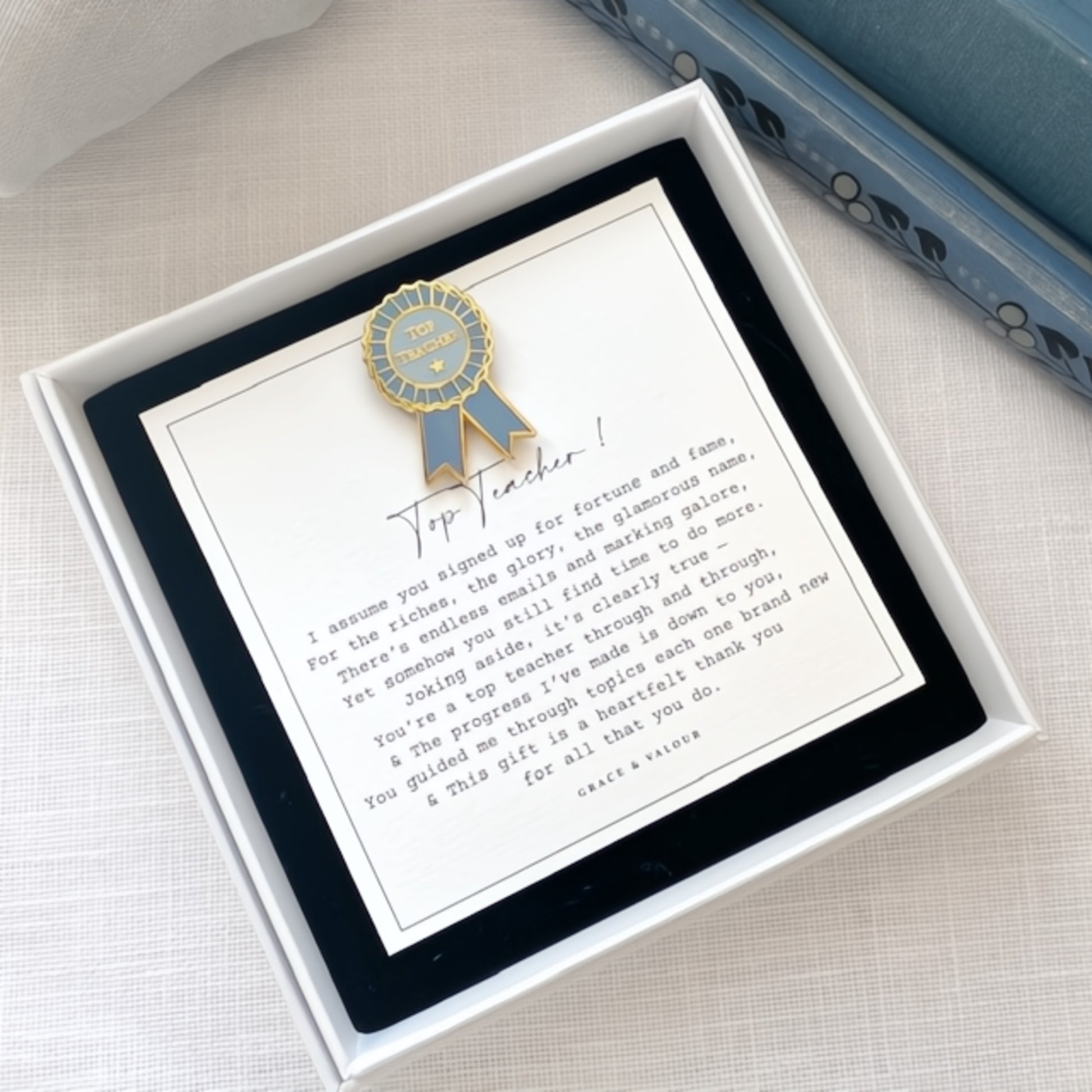 Greeting card with a blue ribbon and text in a white box on a light background