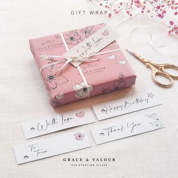 
gift wrapping Grace and Valour pink floral gift wrap with tag and white ribbon and bow