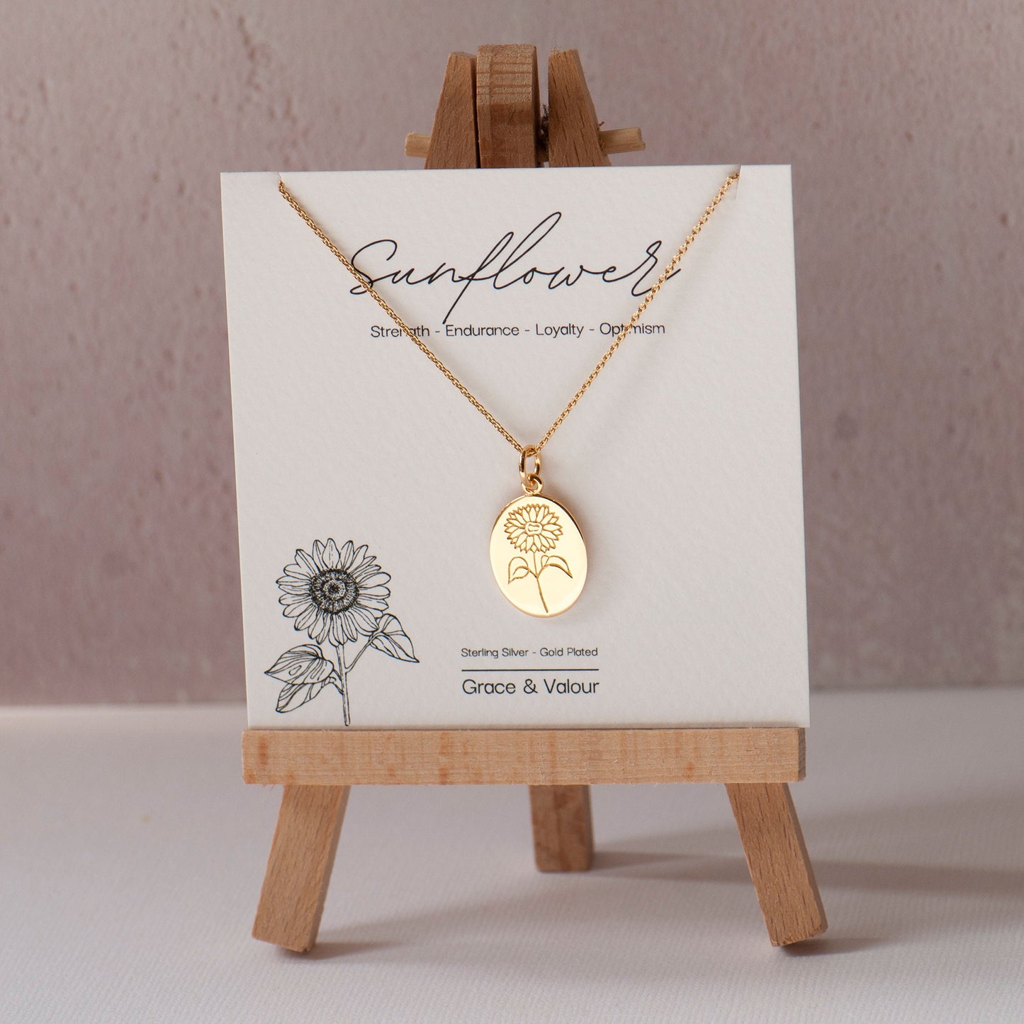 Sunflower gift card with a sunflower necklace engraved in gold made from Sterling Silver on a stand