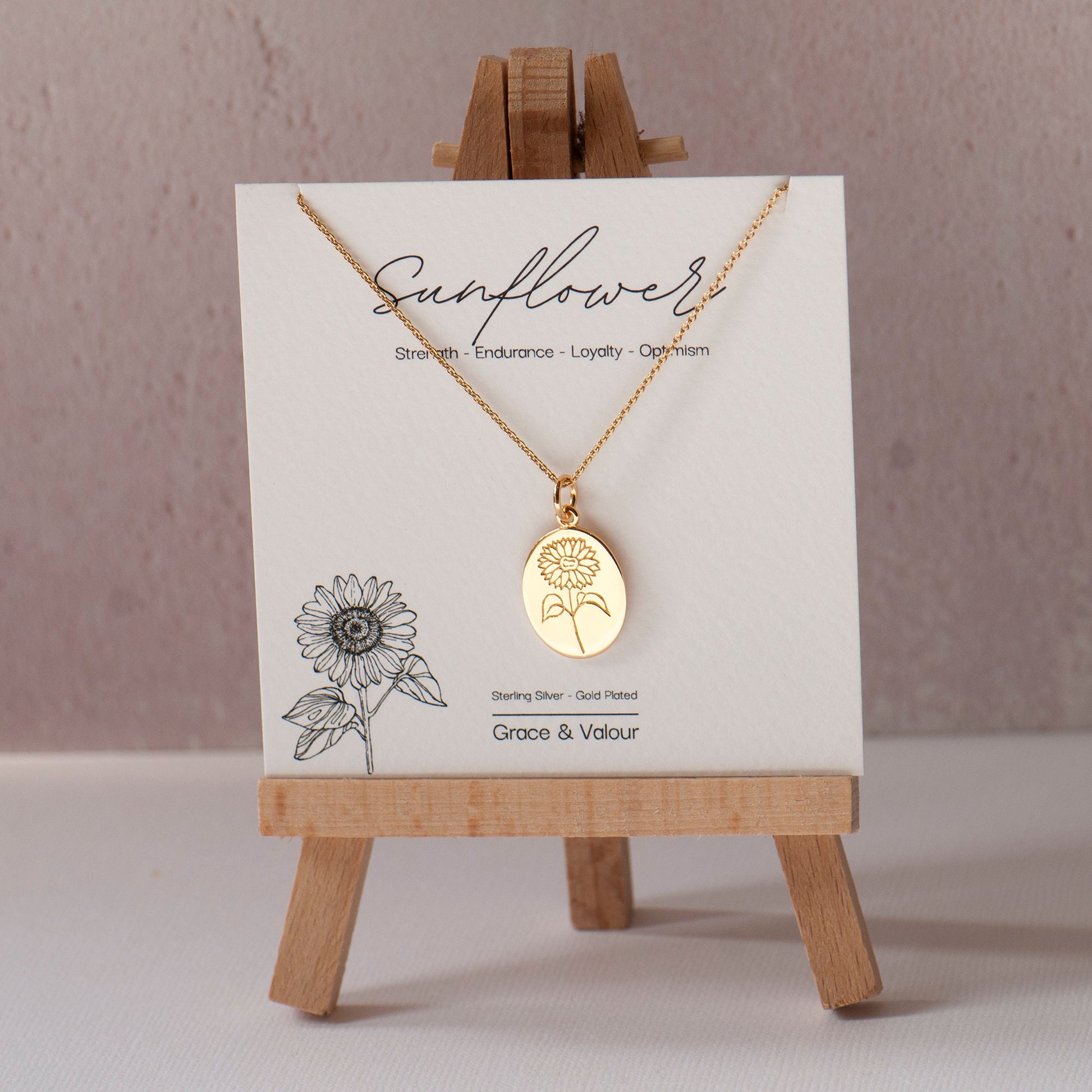 Sunflower gift card with a sunflower necklace engraved in gold made from Sterling Silver on a stand
