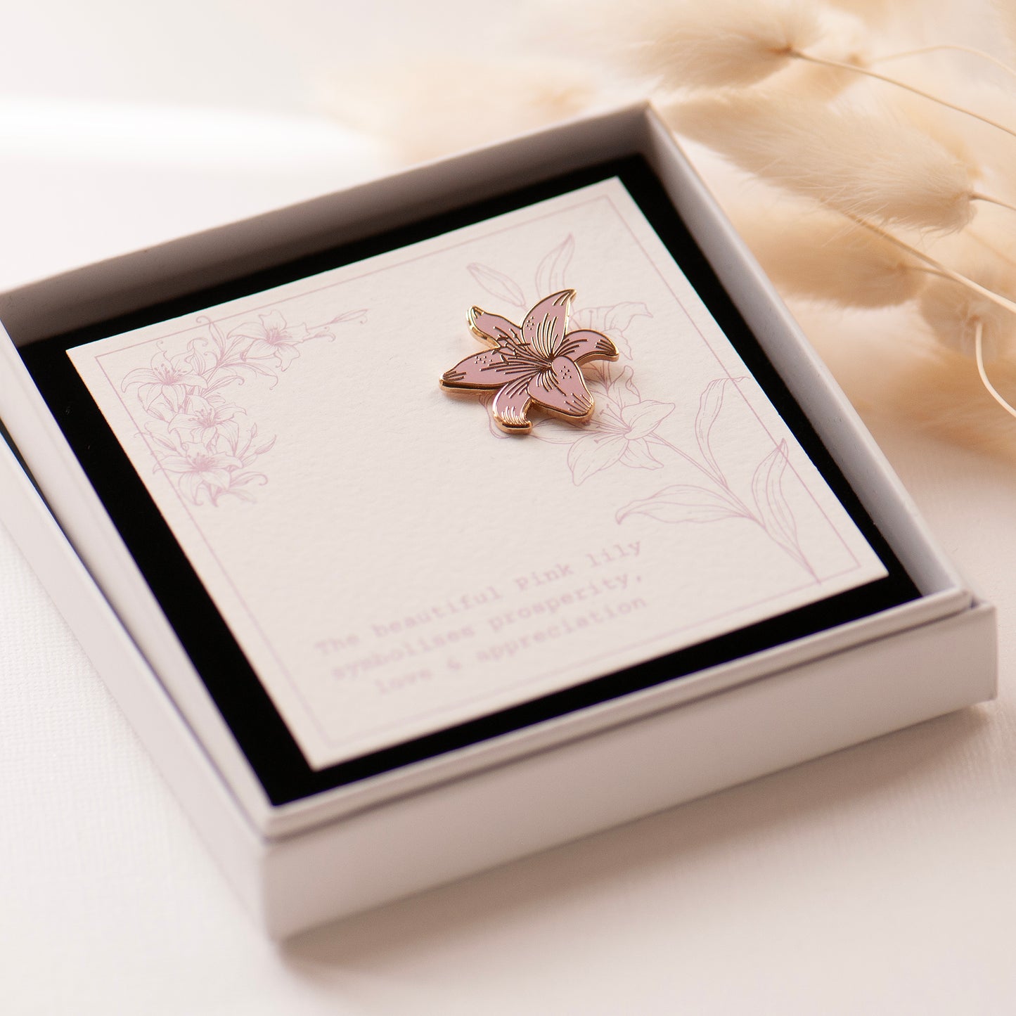 Pink and gold detailed stargazer lily enamel pin on my bespoke lily gift card which says 'The beautiful pink lily symbolises prosperity, love & appreciation'. Presented in an an elegant white gift box.  gifts under £10, flower gifts