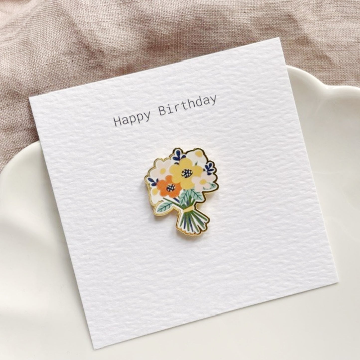 Floral pin on a 'Happy Birthday' card.
