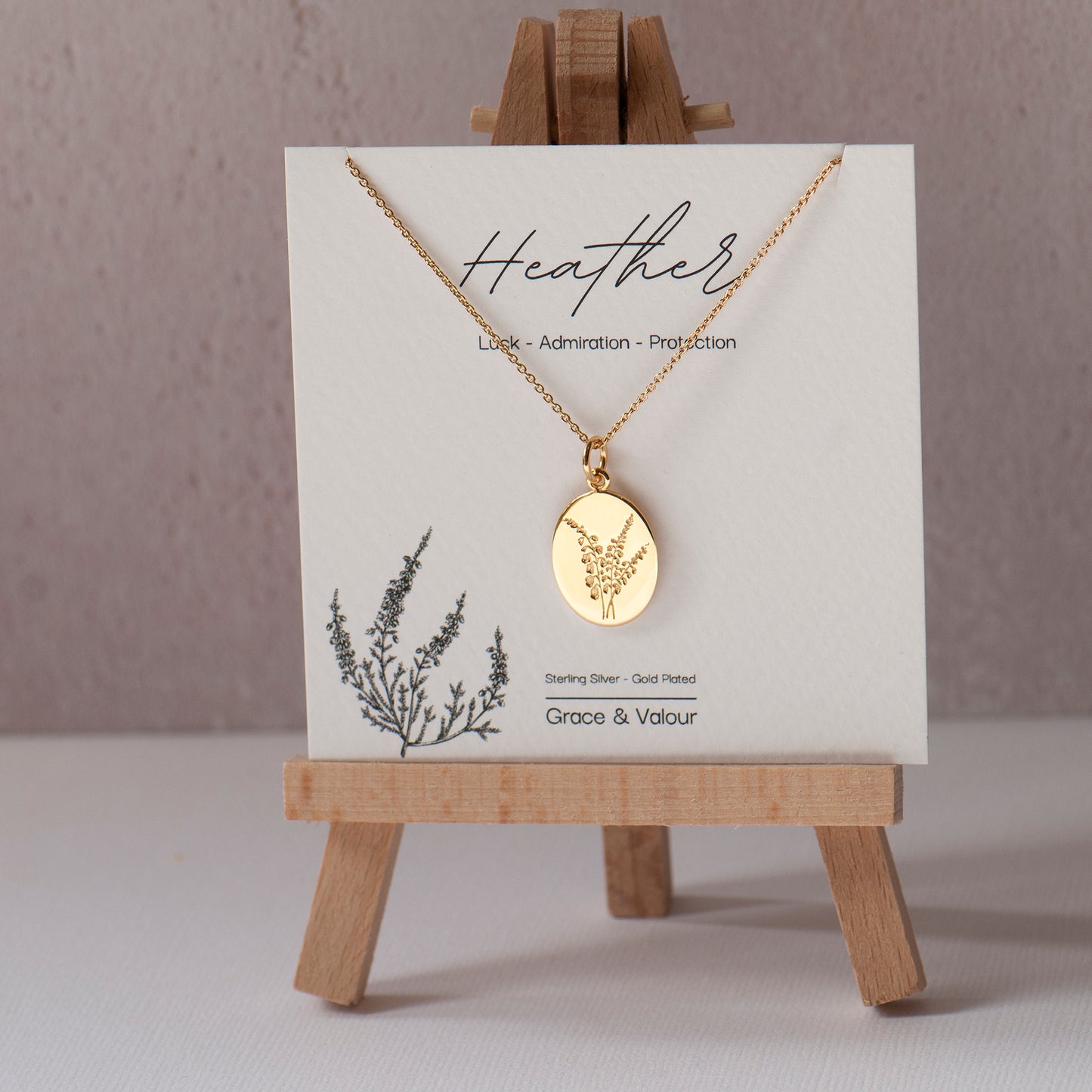 Gold plated sterling silver heather engraved oval floral necklace on a bespoke 'lucky heather' gift card