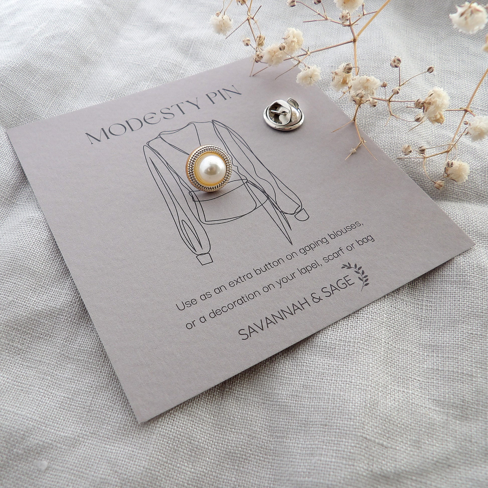 Pearl and gold modesty pin with border edge design