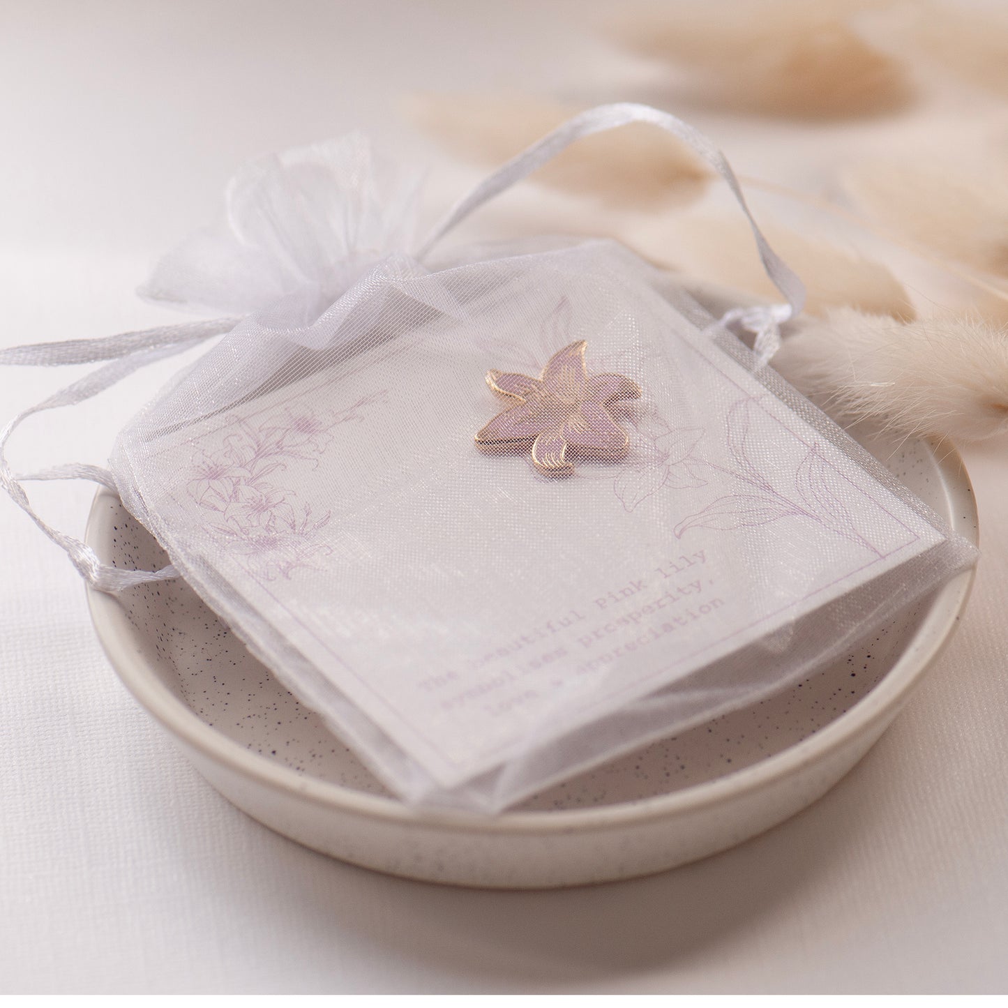 Pink and gold detailed stargazer lily enamel pin on my bespoke lily gift card which says 'The beautiful pink lily symbolises prosperity, love & appreciation'. Presented in an a sweet white chiffon pouch.  gifts under £10, flower gifts