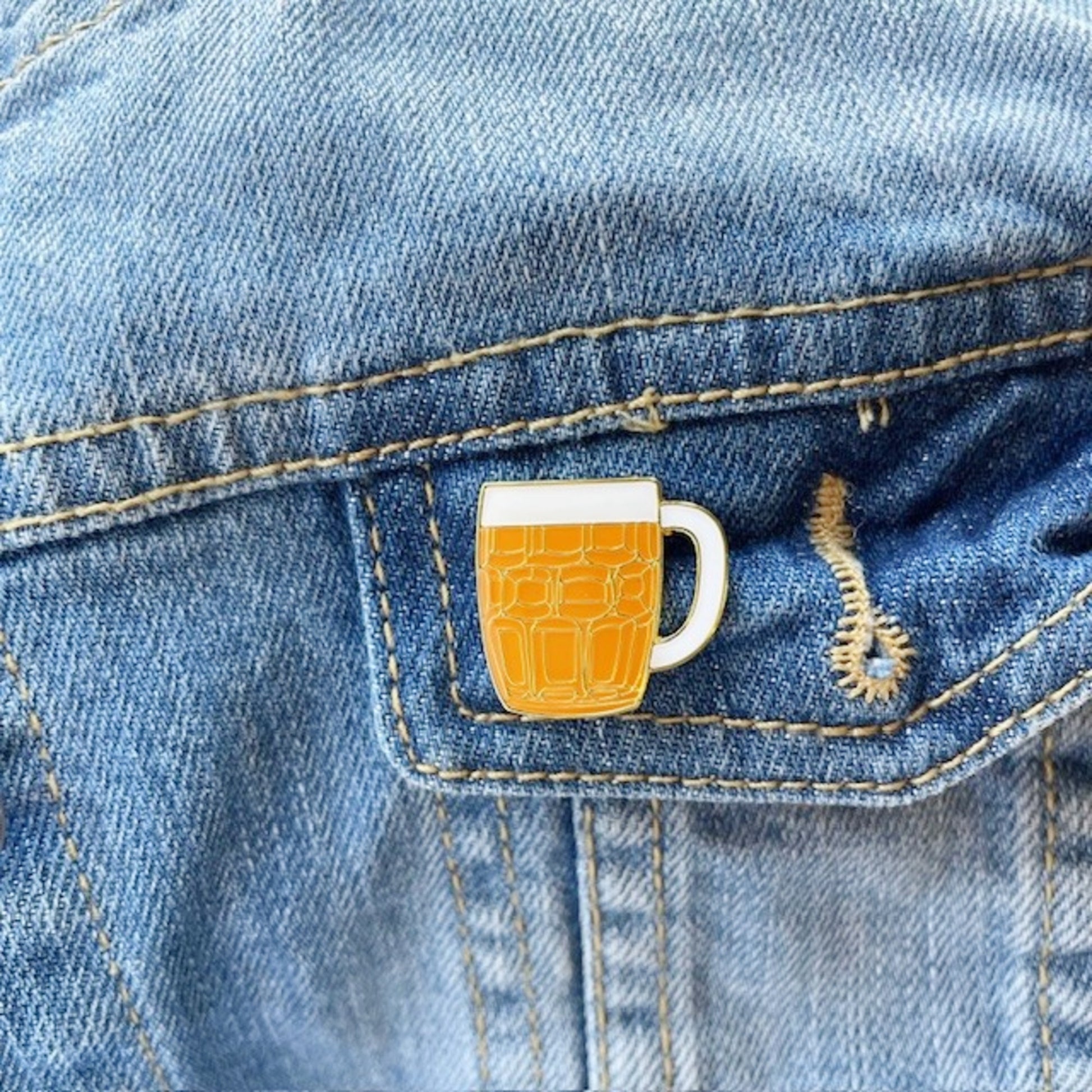 Beer mug pin on a denim jacket